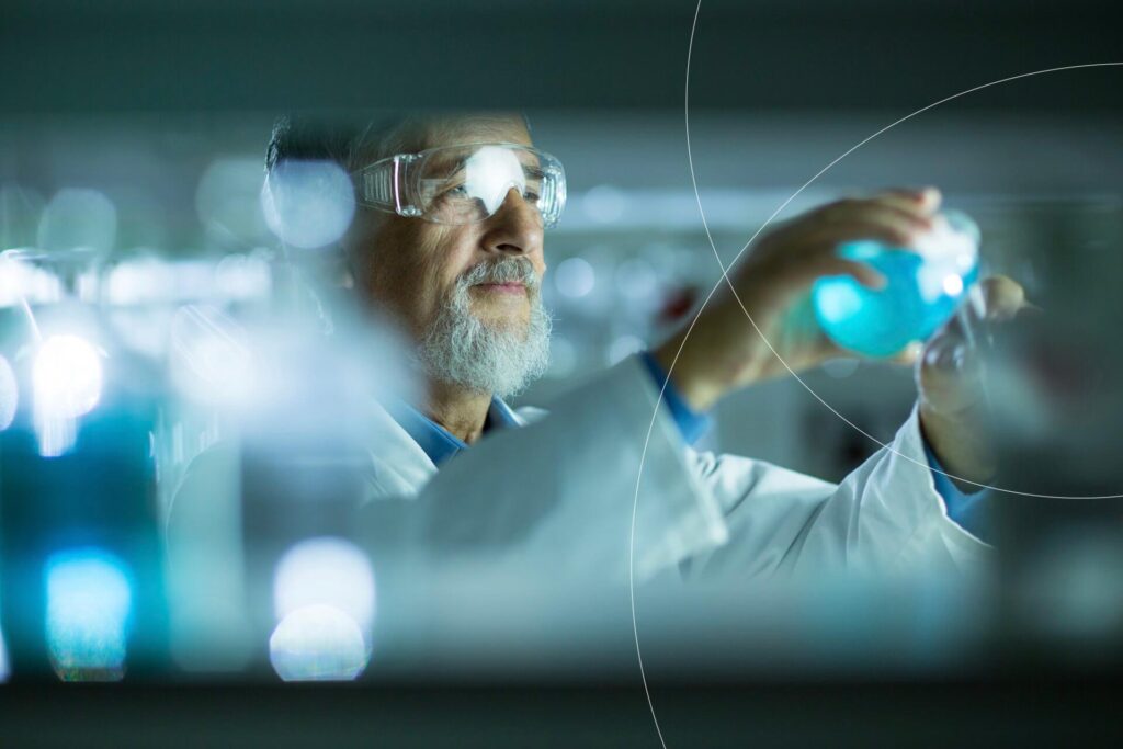 A seasoned biotech researcher evaluates a chemical substance, embodying SCIRENT's specialized expertise in cardiovascular medicine trials.
